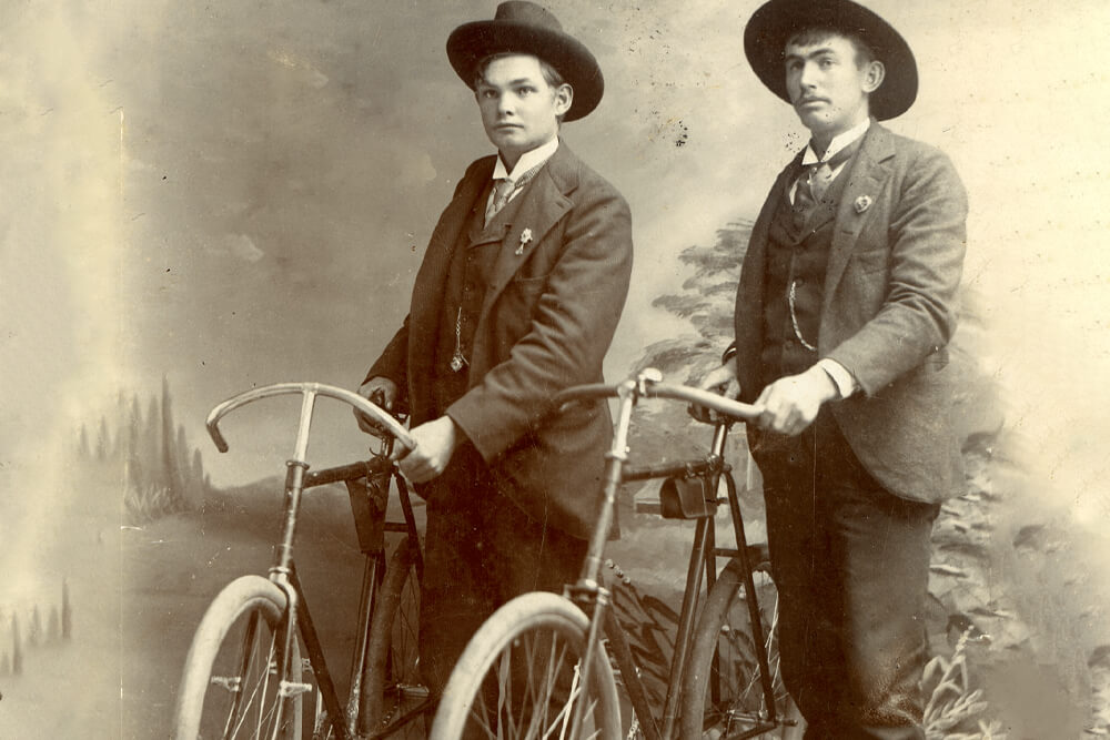 historical photo of men riding fat tire bicycles